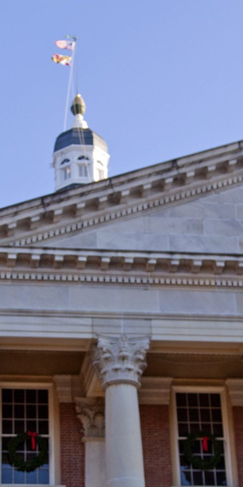 Maryland state house with maryland flag in foreground