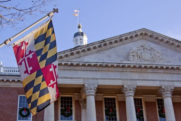Maryland state house with maryland flag in foreground